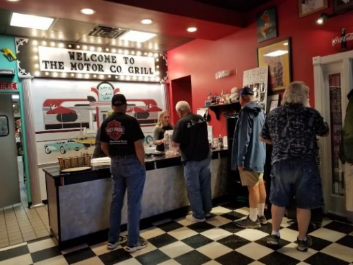 People ordering at counter of the Motor Co. Grill